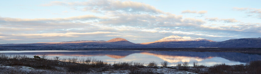 Fototapeta na wymiar Thingvallavatn lake with reflection of sun during winter near sunrise panorama
