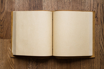 open book with blank pages on wooden floor