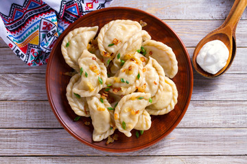 Dumplings, filled with cabbage. Varenyky, vareniki, pierogi, pyrohy - dumplings with filling. View...