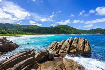 Fototapeta na wymiar water fountain over granite rocks,wild tropical beach with palms, seychelles 7
