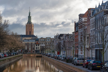 Fototapeta premium Saint James church reflected on the canal calm water nested to the royal stable, in The Hague