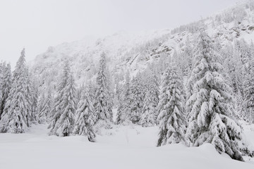 Winter alpine landscape in National Park Retezat, Carpathians, Romania, Europe. Snow covered moutains scenery.