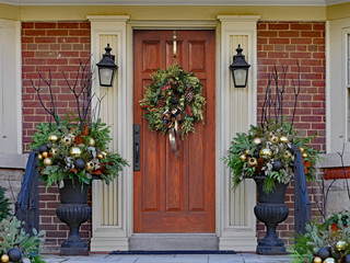 wooden front door with wreath and festive decorations