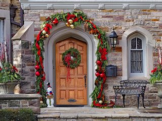 wooden front door with wreath and festive decorations © Spiroview Inc.