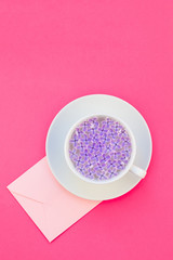 Cup of beautiful lilac flowers infused water