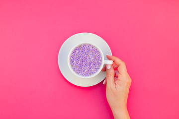Cup of beautiful lilac flowers infused water