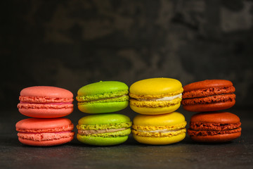 macaron or macaroon cake, colorful cookies (dark background). copy space