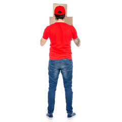 Delivery man in red uniform holding box package back view isolated on white background