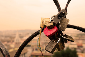 Rome, Italy - October  12, 2018: Lovers padlocks on a bridge. View from the Pincian hill in Rome, Italy