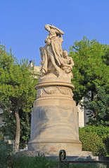 Fototapeta na wymiar Public XIX century sculpture of the famous British poet Lord Byron crowned by personification of Greece in the National Garden in Athens, Greece with blue sky copy space.
