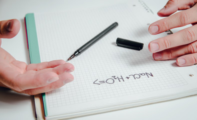 The man solves the chemistry task. Science of chemistry and exact sciences. The concept of solving complicated physical and chemical tasks.