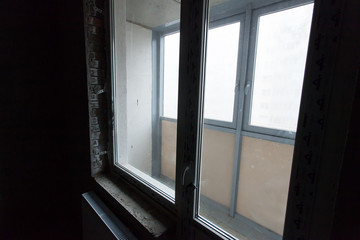 Unfinished building interior, gray room. Repairs in the apartment. Preparing in the room.