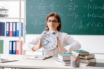 Female math teacher in front of the chalkboard 