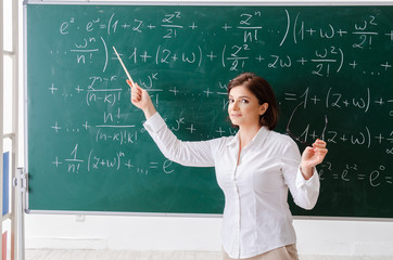 Female math teacher in front of the chalkboard 
