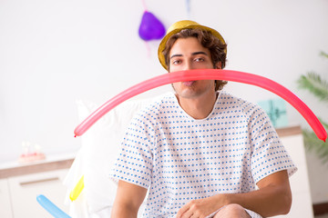 Young man celebrating his birthday in hospital