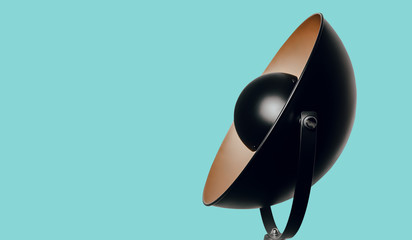 Modern retro-style black lamp. Lamp isolated on a pastel background in the form of a lampshade and photographic lamp. Minimalism, care for furnishing the flat.
