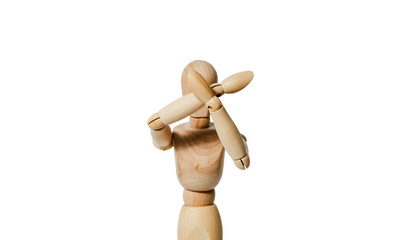 A wooden mannequin covers his face with his hands on white background. The concept of reducing and harassing people. Personal problems of people, ridicule. Defense of people against people.
