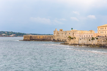 Fototapeta na wymiar Waterfront with Maniace Castle on Ortygia Island in Syracuse