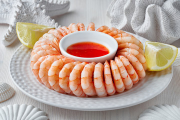 Close-up on shrimp ring with sause on light background