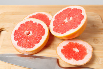 Fototapeta na wymiar sliced grapefruit on a wooden kitchen Board. side view