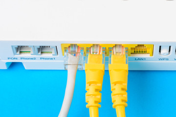 internet modem router hub with a cable connecting on blue background