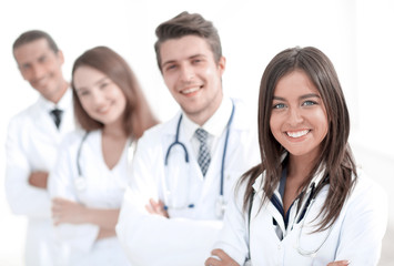 Fototapeta premium female doctor with group of happy successful colleagues