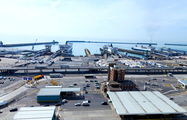 Busy Port of Dover docks . Cars and trucks with cargo queuing to embark ferry for channel crossing .