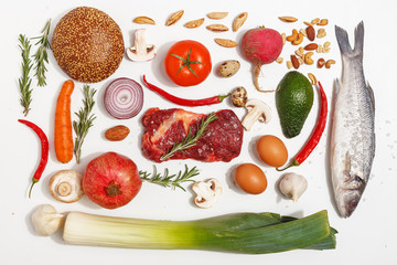 Healthy food clean eating selection: fruit, vegetable, seeds, fish, meat, leaf vegetable on white background. Top view.