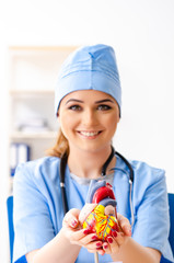 Young female doctor cardiologist sitting at the hospital 
