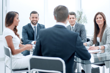 group of business people sitting at a table at an office working meeting