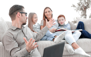 happy family discussing something sitting in their living room.