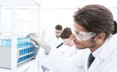 close-up of a happy male scientist wearing safety glasses