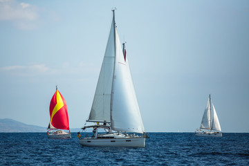 Sailing boats participate in sail yacht regatta in the Aegean Sea.