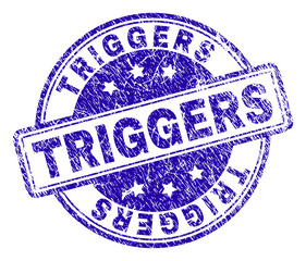 TRIGGERS stamp seal watermark with distress texture. Designed with rounded rectangles and circles. Blue vector rubber print of TRIGGERS text with grunge texture.