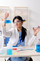 Female chemist working at the lab  