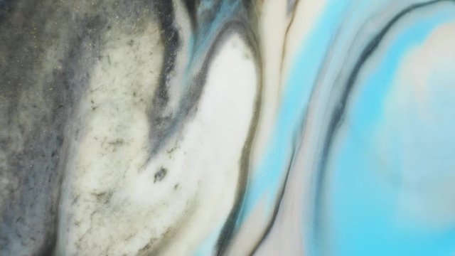 Colorful paint with silver particles organically moves in the liquid