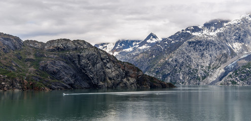 Johns Hopkins Glacier and mountains on a cloudy day in Glacier Bay, Alaska