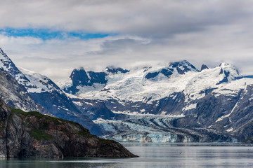 Johns Hopkins Glacier and mountains on a cloudy day in Glacier Bay, Alaska