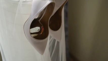White bridal shoes at the morning and veil closeup