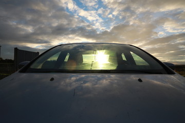 Fototapeta na wymiar car with sunset in the glass reflect