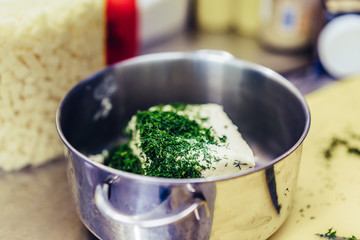 Cutted Dill on Top of The Butter in the Steel Pot