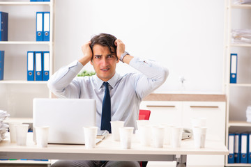 Young employee addicted to coffee