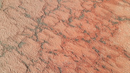 Red colored damaged road or paved pathway with crackes