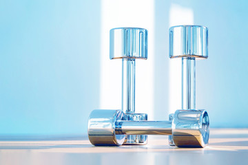 Rows of chrome dumbbells in the gym 