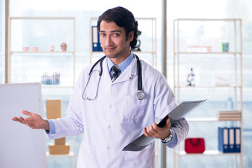 Young handsome male radiologist in front of whiteboard 