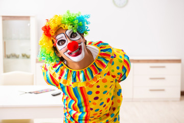 Male clown preparing for perfomance at home 