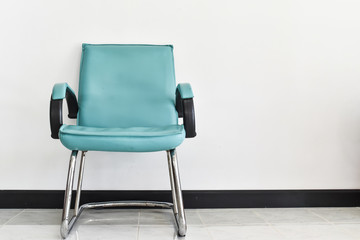Blue chair decorative standing in interior with white wall