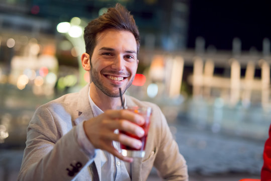Smiling Man Drinking A Cocktail