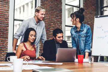 Group of casual business discussing and working with laptop computer.creative business people planning and brainstorm in modern workloft.Teamwork concept