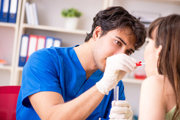 Doctor getting saliva test sample in clinic hospital